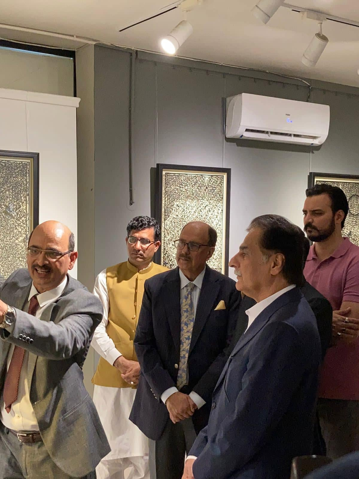 Visitors attending a Tusif Ahmad Islamic papercutting exhibition and artist talk
